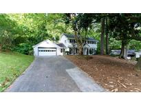Charming two-story white home with attached garage and lush landscaping at 3873 Rains Ne Ct, Brookhaven, GA 30319