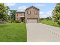 Inviting two-story brick home with a well-manicured lawn and a spacious driveway at 8553 Braylen Manor Dr, Douglasville, GA 30134