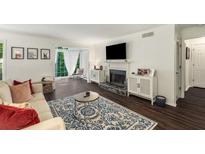 Bright living room featuring a fireplace, white walls, hardwood floors and a large window at 2703 Country Park Dr, Smyrna, GA 30080