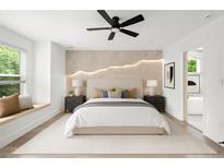 Bright main bedroom with ensuite bath, accent wall, ceiling fan, and large window seat at 32 Wadley Nw St, Atlanta, GA 30314