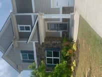 Charming two-story home with stone accents, landscaping, and inviting front entrance at 4480 Merrigold Way, Fairburn, GA 30213