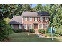 Charming two-story brick home with black shutters and lush green landscaping at 1131 Steeple Run, Lawrenceville, GA 30043