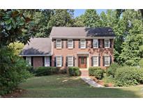 Charming two-story brick home with black shutters and a beautifully landscaped front yard at 1131 Steeple Run, Lawrenceville, GA 30043
