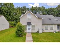 Inviting two-story home with a well-maintained lawn and charming curb appeal in a lush, green neighborhood at 6178 Field Stone Dr, Douglasville, GA 30134