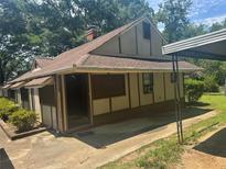 Quaint single-story home with a covered porch and neutral-tone exterior at 718 South Ave, Forest Park, GA 30297