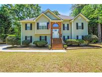 Charming two-story home with manicured lawn and inviting front entrance, perfect for Gathering living at 85 Eastwood Frst, Covington, GA 30014