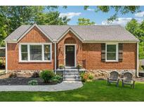 Charming brick home with a manicured lawn, inviting front entry, and a cozy seating area at 2432 Saint Patrick Se St, Atlanta, GA 30317