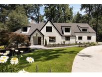 Stunning two-story home featuring a modern painted brick facade and professionally landscaped front yard at 1155 Peachtree Battle Nw Ave, Atlanta, GA 30327