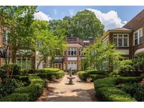 Beautiful brick exterior of 'The Barnett' with manicured courtyard, greenery and fountain at 737 Barnett Ne St # B6, Atlanta, GA 30306