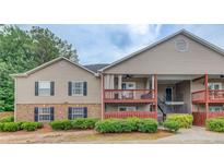 Charming two-story townhouse featuring a mix of stone and siding with inviting balconies and a well-maintained landscape at 405 Brighton Pt, Atlanta, GA 30328