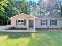 Charming single-story home featuring a well-maintained lawn and inviting front entrance at 413 Old Brock Rd, Rockmart, GA 30153
