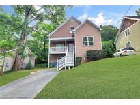 Charming two-story home with a welcoming front porch and well-manicured lawn at 381 New Jersey Ave Nw, Atlanta, GA 30314