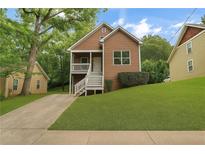 Charming two-story home featuring a welcoming front porch and well-manicured lawn at 381 New Jersey Nw Ave, Atlanta, GA 30314