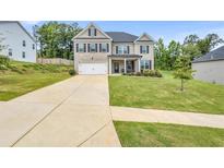 Charming two-story brick home with a well-manicured lawn and a two-car garage at 4323 Cannon Walk, Ellenwood, GA 30294
