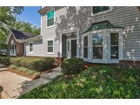Charming two-story home featuring a well-manicured lawn and beautiful landscaping, offering great curb appeal at 52 Sutton Pl, Avondale Estates, GA 30002