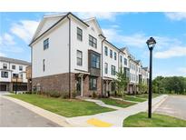 Charming townhome showcases white painted brick and black framed windows at 5440 Howington Ct # 190, Buford, GA 30518