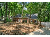 Charming single-story brick home surrounded by lush, mature trees in a peaceful setting at 80 Cliffcreek Trce, Atlanta, GA 30350