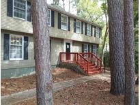 Charming two-story home featuring a classic design and inviting front porch with red stairs at 110 Paddock Trl, Peachtree City, GA 30269