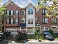 Charming brick townhome showcasing a multi-car garage and inviting curb appeal at , Atlanta, GA 30342
