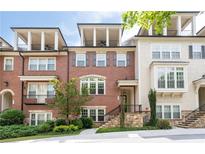 Beautiful brick townhome with a balcony and a manicured front yard in a desirable community at 4089 Thorndale Ln # 13, Smyrna, GA 30080