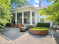Stately home featuring classic architecture, a circular driveway, and a manicured front yard at 893 Piedmont Ne Ave # 5, Atlanta, GA 30309