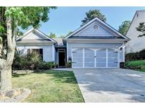 Charming single-story home with a well-manicured lawn and a two-car garage in a suburban neighborhood at 2220 Lily Valley Dr, Lawrenceville, GA 30045