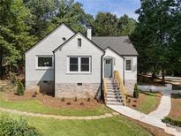 Charming painted brick home with stone foundation and manicured front yard at 2249 Beecher Sw Rd, Atlanta, GA 30311