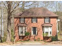Charming two-story brick home featuring bay windows and a classic black front door at 1537 Mcadoo Sw Dr, Marietta, GA 30064