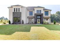 Beautiful new construction home with a lawn, stone accents, and modern windows at 2900 Waterford Dr Sw, Conyers, GA 30094