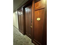 Apartment front door with dark wood finish, number 211, and decorative paneling at 77 Peachtree Ne Pl # 211, Atlanta, GA 30309