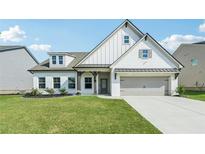 Charming two-story home featuring white brick, a well-manicured lawn, and a gray two-car garage at 35 Henson Farm Dr, Loganville, GA 30052