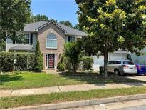 Charming two-story home with a brick facade, mature trees and well-manicured landscaping, offering great curb appeal at 3140 Ridge Hill Pkwy, Douglasville, GA 30135