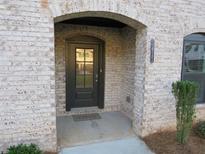 Charming brick home entrance with a welcoming black door, brick archway, and visible house number at 3411 Swallowtail Ter, Duluth, GA 30096