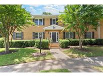 Apartment building with a manicured lawn, sidewalk, and mature trees in a garden-like setting at 3510 Roswell Nw Rd # N3, Atlanta, GA 30305