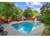 Refreshing backyard pool surrounded by lush greenery and a relaxing patio area at 4648 Danna Dr, Austell, GA 30106