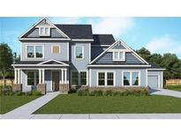 Charming two-story home featuring a covered porch, well-manicured lawn, and traditional architectural details at 507 Barnfield Way, Dallas, GA 30157