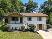 Charming renovated two-story home with modern updates and a lush, landscaped front yard at 1409 Georgia Ave, East Point, GA 30344