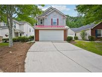 Charming two-story home featuring a two-car garage, red roof, and landscaped front yard at 231 Silver Fox Trl, Dallas, GA 30157