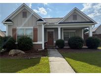 Charming single-story home with a welcoming covered porch and professionally landscaped front yard at 2979 Dungeness Dr, Douglasville, GA 30135