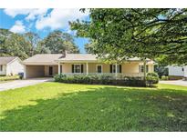 Charming single story home with a covered front porch and lush green lawn on a sunny day at 338 Patterson Rd, Lawrenceville, GA 30044