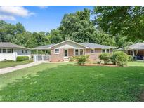 Charming brick home featuring a well-maintained lawn and mature trees in a desirable neighborhood at 2483 Hunting Valley Dr, Decatur, GA 30033