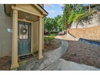 Charming front entrance with a wreath, a 'hello' door mat, and classic architectural pillars at 3048 Briarcliff Ne Rd # 9, Atlanta, GA 30329