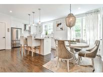 Modern kitchen featuring stainless steel appliances, pendant lighting, and an island with barstool seating at 68 Peachtree Memorial Nw Dr # 68-5, Atlanta, GA 30309