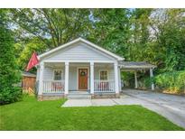 Charming craftsman home with a covered front porch and a convenient carport at 727 Holmes Nw St, Atlanta, GA 30318