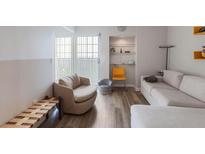 Bright living room featuring contemporary furnishings and a sliding glass door at 199 14Th Street Northeast Ne St # 2501, Atlanta, GA 30309