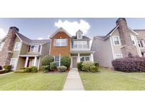 Charming townhome with brick and siding exterior, well-maintained landscaping, and inviting entrance at 2320 Polaris Sw Way, Atlanta, GA 30331