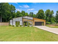 Stunning modern home with a well-manicured lawn and stylish architectural design at 90 Mckown Rd, Fayetteville, GA 30214