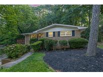 Charming brick home with mature trees, well-maintained landscaping, and inviting facade at 2286 Capehart Ne Cir, Atlanta, GA 30345