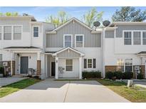 Charming two-story townhouse with grey and white exterior, a well-maintained lawn, and private driveway at 4457 Watson Ridge Dr, Stone Mountain, GA 30083