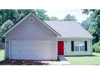 Charming single-story home featuring a red front door, attached garage, and well-maintained lawn at 4190 Wingfoot Ct, Decatur, GA 30035